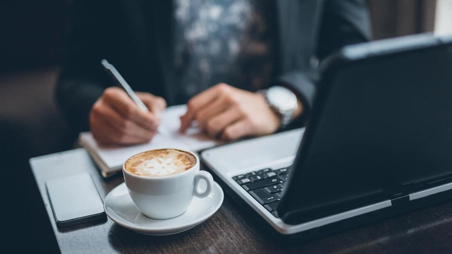 man writing on desk